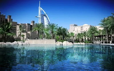 Burdż al-Arab nad wodną laguną i palmami w Dubaju