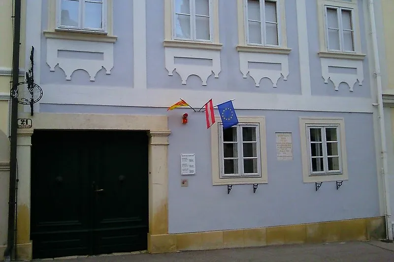 Fasada Domu Haydna w Eisenstadt z flagami Austrii, Burgenlandu i Unii Europejskiej