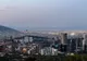 Panorama Monterrey o zmierzchu z wieżowcami, flagą Meksyku i górami w tle