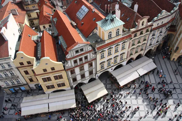 Widok z góry na kamienice i tłum turystów na Rynku Staromiejskim w Pradze