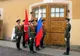 Żołnierze warty honorowej z flagami przed drewnianymi drzwiami w Twierdzy Pietropawłowskiej