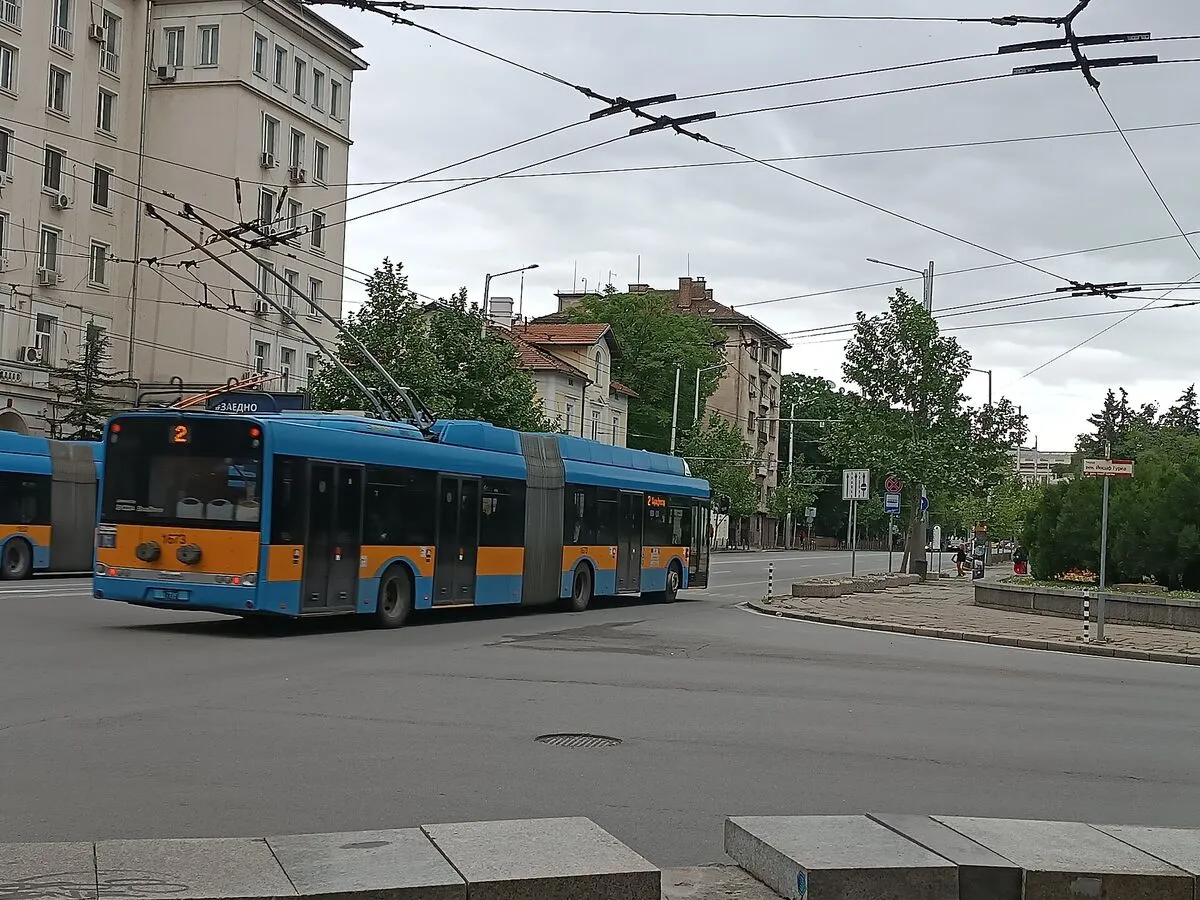 Niebiesko-żółty przegubowy trolejbus linii 2 na ulicy w centrum Sofii