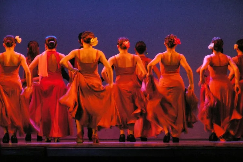 Tancerki flamenco w czerwonych sukniach na scenie